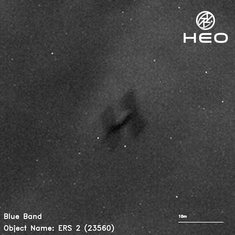 ein verschwommenes Schwarz-Weiß-Bild eines H-förmigen Satelliten vor einem Hintergrund aus einigen Dutzend Sternen