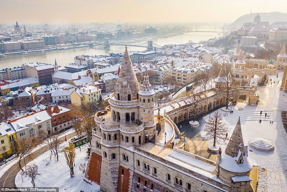 Above is a bird's eye view of the Fisherman's Bastion monument in a snow-covered Budapest. The stunning Hungarian city often experiences sub-zero temperatures during the winter months, but BudapestFlow says 'don't let that put you off visiting' - from cosy bars to the hot spring water in the thermal baths, the travel site says there are plenty of ways to warm up