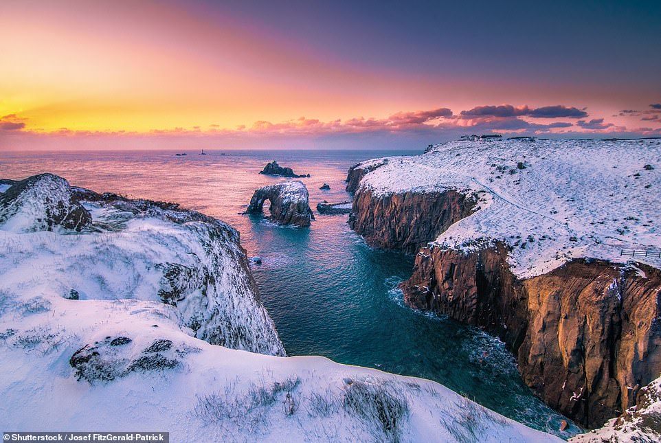 Most tourists flock to Cornwall in the summer months to sunbathe on its beautiful beaches and swim in the sea. But those who travel off-peak can be rewarded with breathtaking winter landscapes - and fewer crowds. Pictured above is a snowy Land's End on the Penwith peninsula
