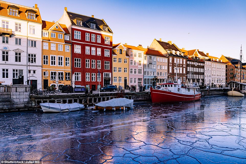 Above is a colourful row of houses next to an icy Nyhavn waterfront - one of the most iconic spots in Copenhagen. Visit Copenhagen notes winter as being 'the season of hygge', a time of contentment with 'woollen sweaters, candlelight and good times'