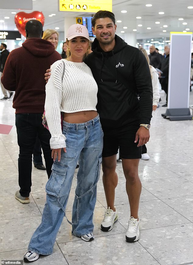 Georgia flashed her abs in a white cropped jumper which she teamed with high-waisted blue jeans