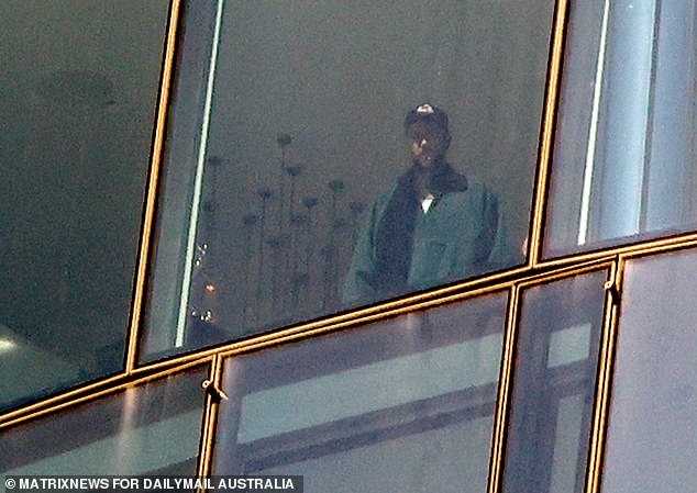 Travis Kelce was spotted admiring the views from a lavish Sydney hotel room after touching down in Australia on Thursday morning. Pictured