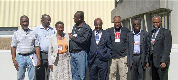 Sekazi Mtingwa und andere Forscher stehen vor einem Gebäude in Südafrika
