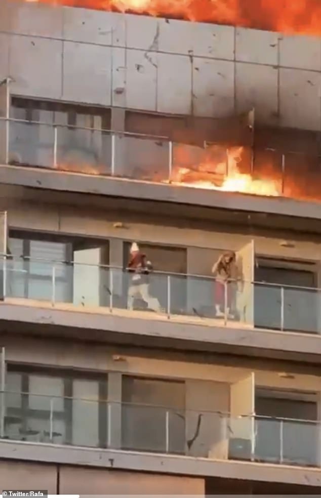Dramatische Aufnahmen zeigen zwei Bewohner, die verzweifelt versuchen, sich vor dem Feuer zu schützen.  Mehrere Menschen wurden von der Feuerwehr von ihren Balkonen gerettet