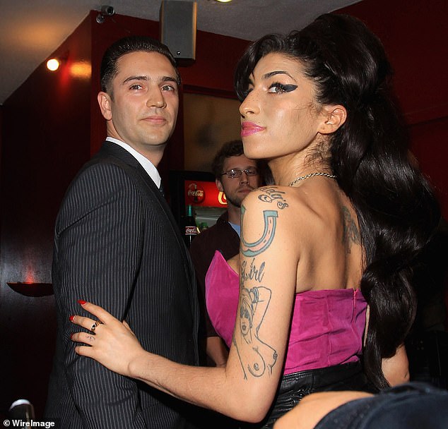 Amy Winehouse pictured with her finance Reg Traviss on July 13 2010