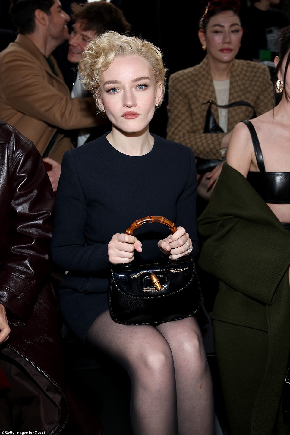 Julie carried her essentials in a small black clutch bag which had a wooden handle