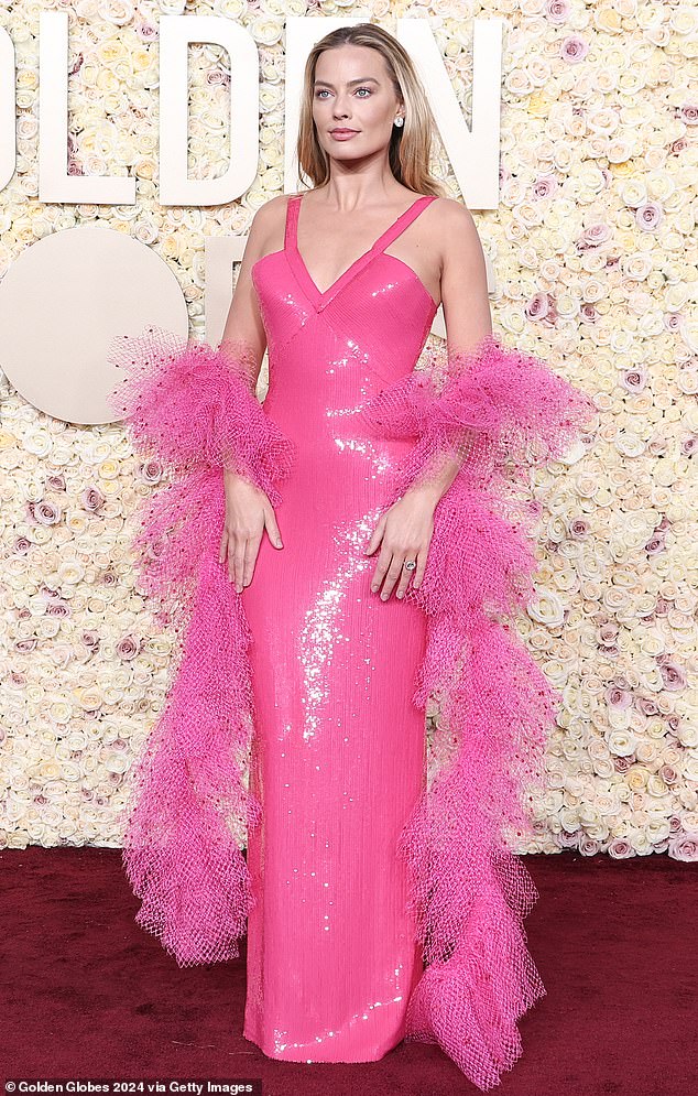 Margot's pink persistence hasn't yet stopped. Pictured at the Golden Globe Awards in California last month