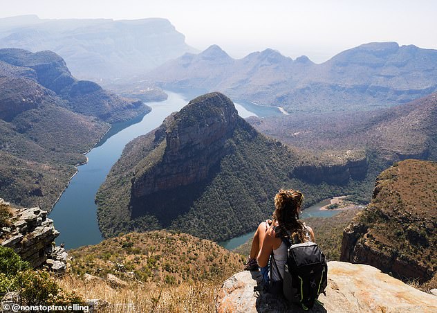 Lauren and Craig choose one corner of the world to explore by road, while living in a van for six to 12 months. Then they sell their van to go backpacking and work to fund their next adventure. Pictured: Lauren taking in the view at Blyde River Canyon, South Africa