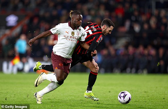 BOURNEMOUTH, ENGLAND - FEBRUARY 24: Adam Smith of AFC Bournemouth is challenged by Jeremy Doku of Manchester City during the Premier League match between AFC Bournemouth and Manchester City at the Vitality Stadium on February 24, 2024 in Bournemouth, England. (Photo by Clive Rose/Getty Images)
