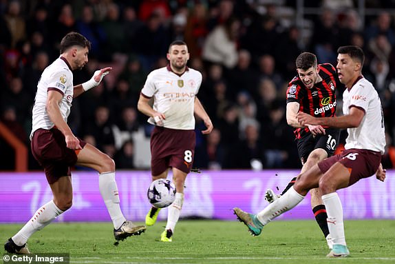 BOURNEMOUT H, ENGLAND - FEBRUARY 24: Ryan Christie of AFC Bournemouth shoots past Ruben Dias of Manchester City during the Premier League match between AFC Bournemouth and Manchester City at the Vitality Stadium on February 24, 2024 in Bournemouth, England. (Photo by Michael Steele/Getty Images)