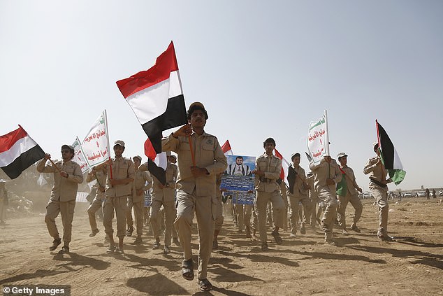 Houthi supporters march at a rally in support of Palestinians on the outskirts of Sana'a, Yemen on February 4, 2024 amid the ongoing Houthi strikes on shipping in the Red Sea and Gulf of Aden