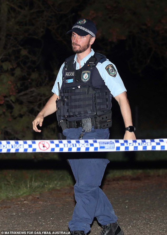 Police are relying on CCTV, toll road payments and GPS mobile data, to piece together the events in the days after the alleged double murder (pictured: an officer at the crime scene on Sunday night)