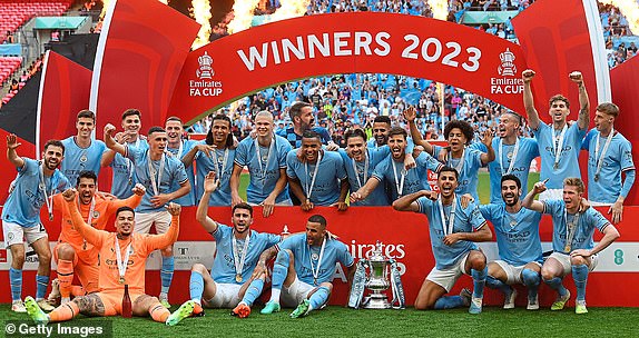 LONDON, ENGLAND - JUNE 03: Players of Manchester City pose for a team photograph with the FA Cup Trophy after defeating Manchester United during the Emirates FA Cup Final between Manchester City and Manchester United at Wembley Stadium on June 03, 2023 in London, England. (Photo by Mike Hewitt/Getty Images)