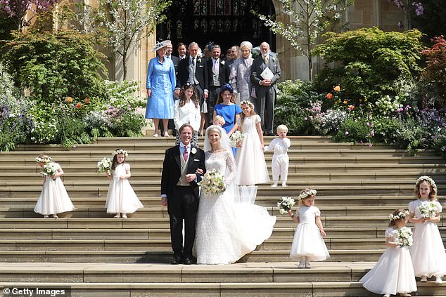 Mr Kingston and Lady Gabriella Windsor posed on the steps of the chapel with their bridesmaids, page boys and guests after their wedding