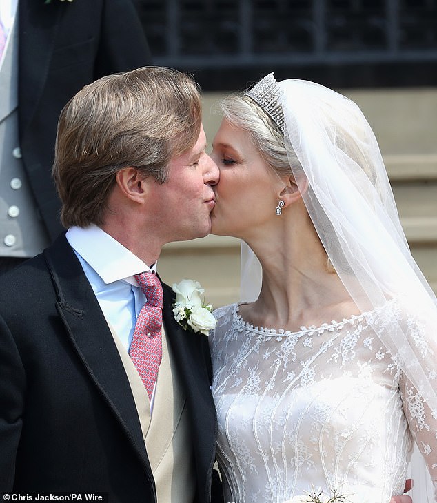 Thomas Kingston and Lady Gabriella Windsor share a kiss on the steps of the chapel after their wedding at St George's Chapel