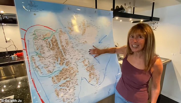 Using a map to demonstrate where polar bears are found, Jo tells her viewers that they can 'pop up anywhere on Svalbard'