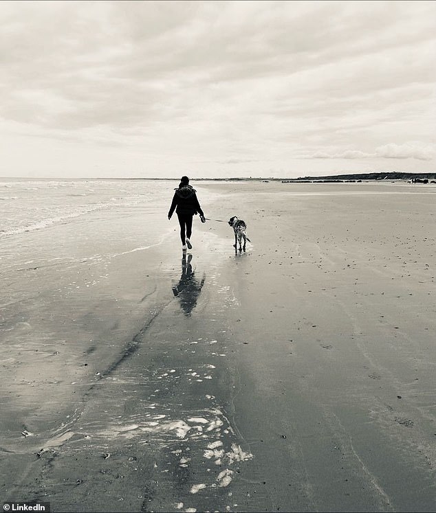 Accompanying her post, Daniella chose a black and white photograph of her walking her dog along the beach