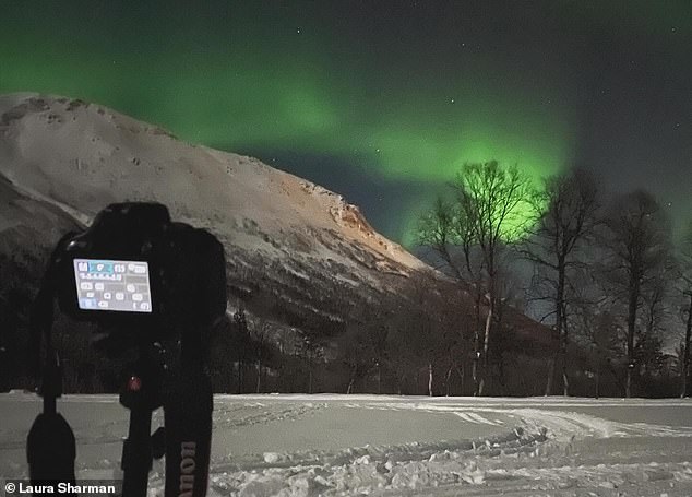 Above: Laura sets up a shot of the Northern Lights using her DSLR camera