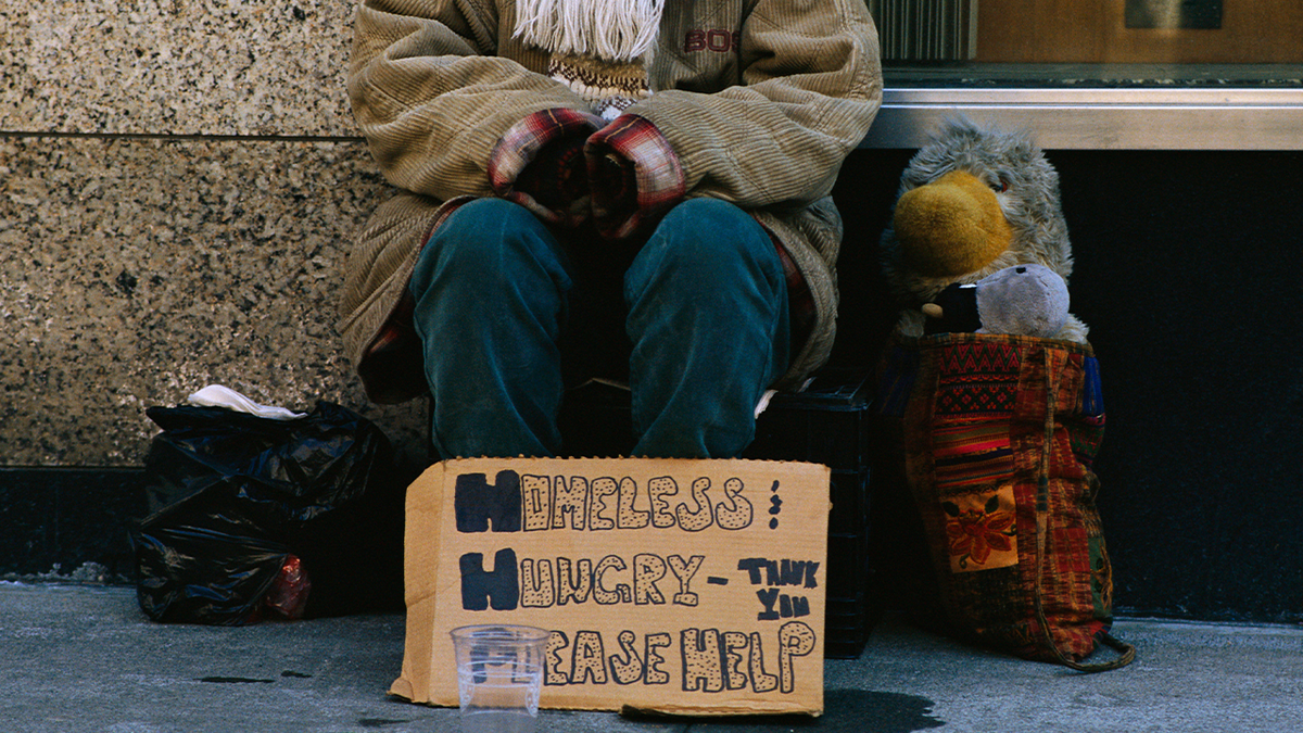 Obdachlose Frau bittet um Hilfe