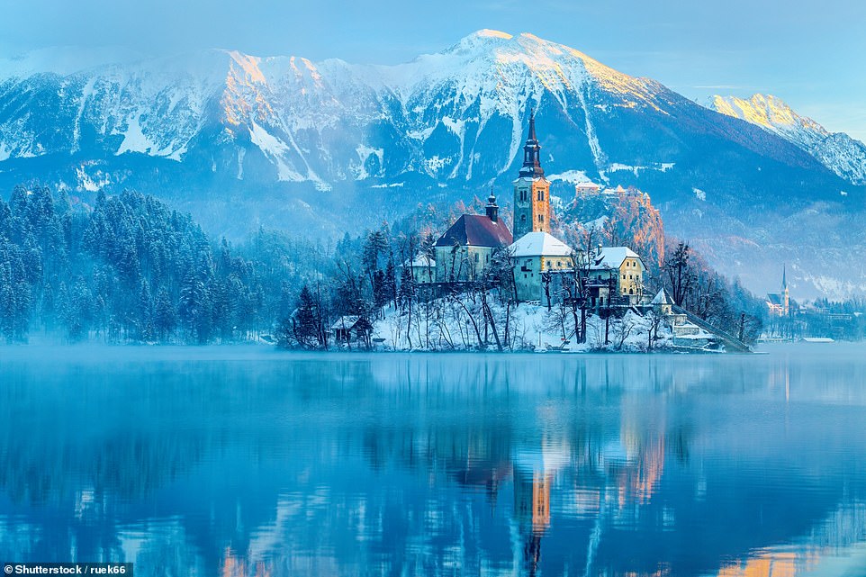 This image shows the iconic Assumption of Maria Church on Bled Island in Slovenia, with the Julian Alps in the background. Lonely Planet notes that its 'over-the-top romantic setting' has long attracted honeymooners, with the scenery even more enamouring when winter mist wafts hither and thither and snow blankets the landscape