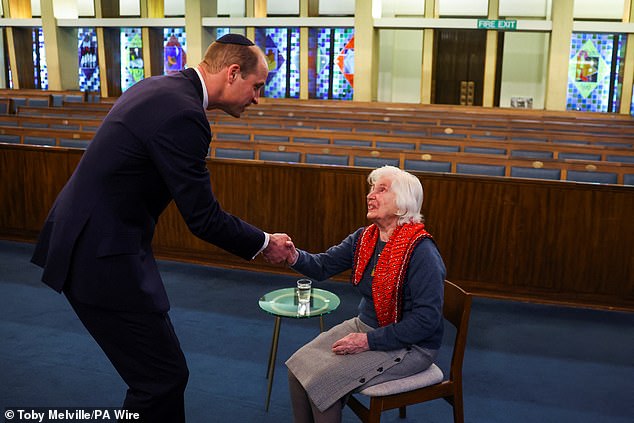 William shakes hands with Renee Salt, 94, a Holocaust survivor, at the synagogue yesterday