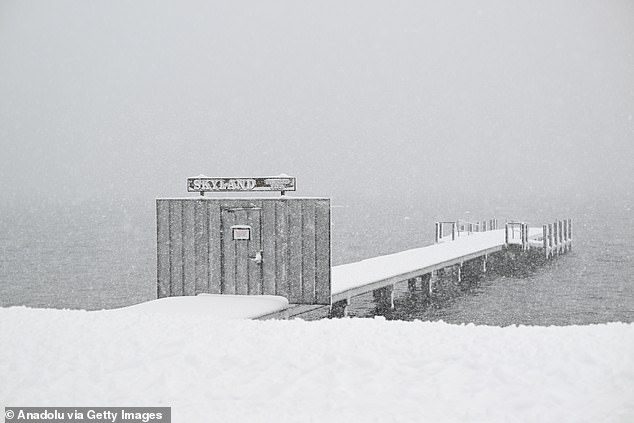 Snow is seen blanketing the dock in Lake Tahoe, California, as a blizzard struck
