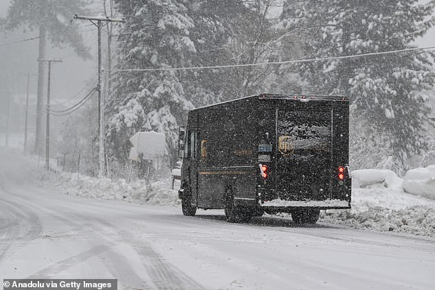 A UPS vehicle is seen as snow blanketed roads in Lake Tahoe, California