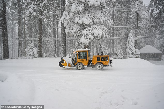 A snowplow clear snow from roads in Lake Tahoe, California