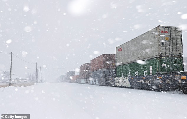 A freight train passes through town as snow falls north of Lake Tahoe in the Sierra Nevada