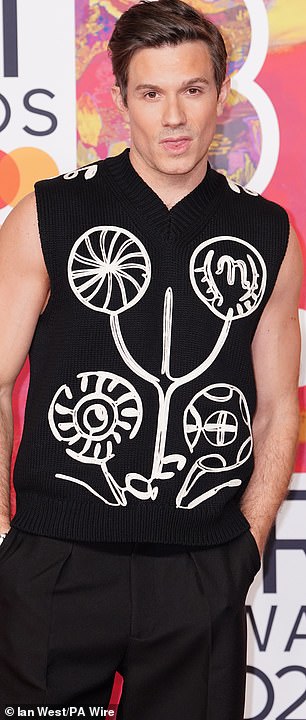 His knitted, sleeveless top featured a white design which made the ensemble eye-catching
