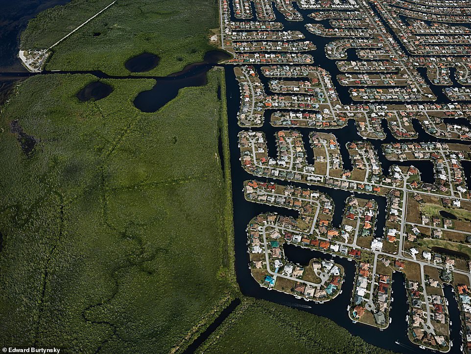 PUNTA GORDA, CHARLOTTE COUNTY, FLORIDA, USA, 2012: The books says: 'This is a detail of Charlotte Park, a neighbourhood of Punta Gorda, Spanish for "fat point". The neighbourhood juts out into an estuary on the west coast of Florida. The Gulf of Mexico region is famously prone to hurricanes, but this community is somewhat protected from surging storm water by a thick mangrove forest whose deep roots stabilise the coastline. Over the last century, however, this estuary has lost up to 60 percent of its vital mangrove forests to urban development. The vermicular street plan was designed to maximise water frontage for as many homes as possible'