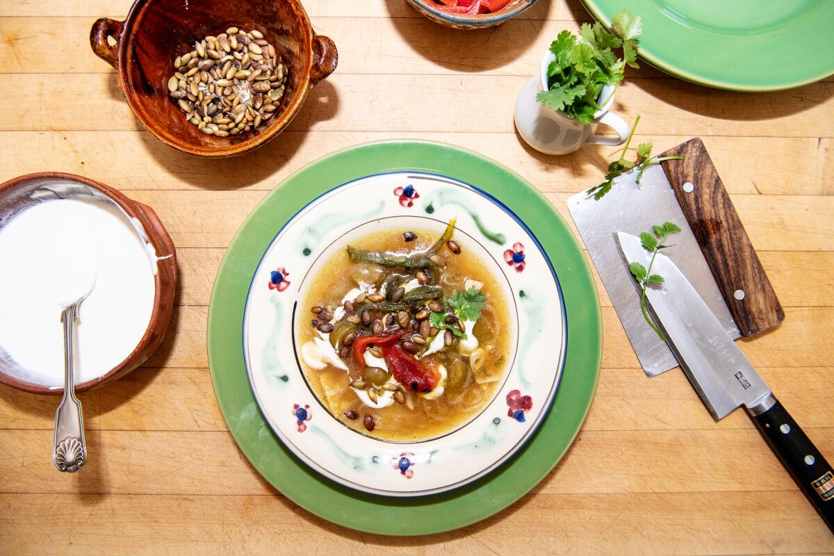 Sally Schmitts berühmte Tomatillo-Tortilla-Suppe auf einem Tisch mit Gewürzen.