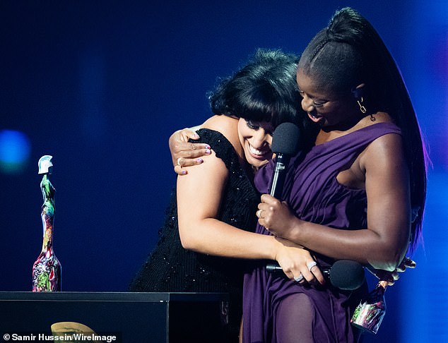 Pictured: BRIT Awards host Clara Amfo hugs Raye after presenting her with an award. The host first played Raye's music 10 years ago on the radio