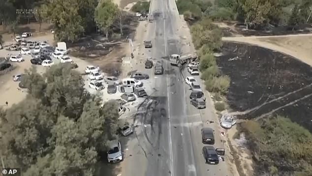 This image from video provided by South First Responders shows charred and damaged cars along a desert road after an attack by Hamas terrorists at the Nova music festival near Kibbutz Re'im in southern Israel on Saturday, October 7, 2023