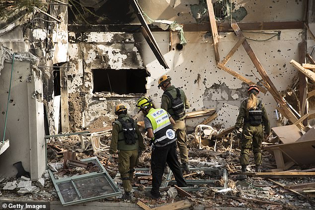 Members of Army rescue and ZAKA crews search for bodies and body parts after the Hamas and Palestinians terrorists attack on Kibbutz Be'eri on October 22, 2023