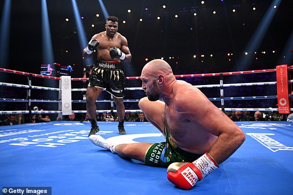 RIYADH, SAUDI ARABIA - OCTOBER 28: Francis Ngannou knocks down Tyson Fury during the Heavyweight fight between Tyson Fury and Francis Ngannou at Boulevard Hall on October 28, 2023 in Riyadh, Saudi Arabia. (Photo by Justin Setterfield/Getty Images)