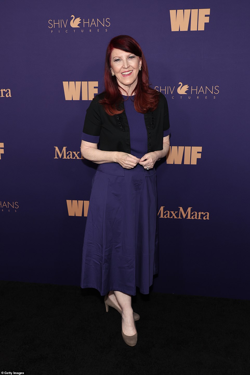 Kate Flannery put on an elegant display for the party and modeled a deep purple dress layered with a matching black, short-sleeved blazer. The Office star sported brown suede pumps and rocked a hot pink lip