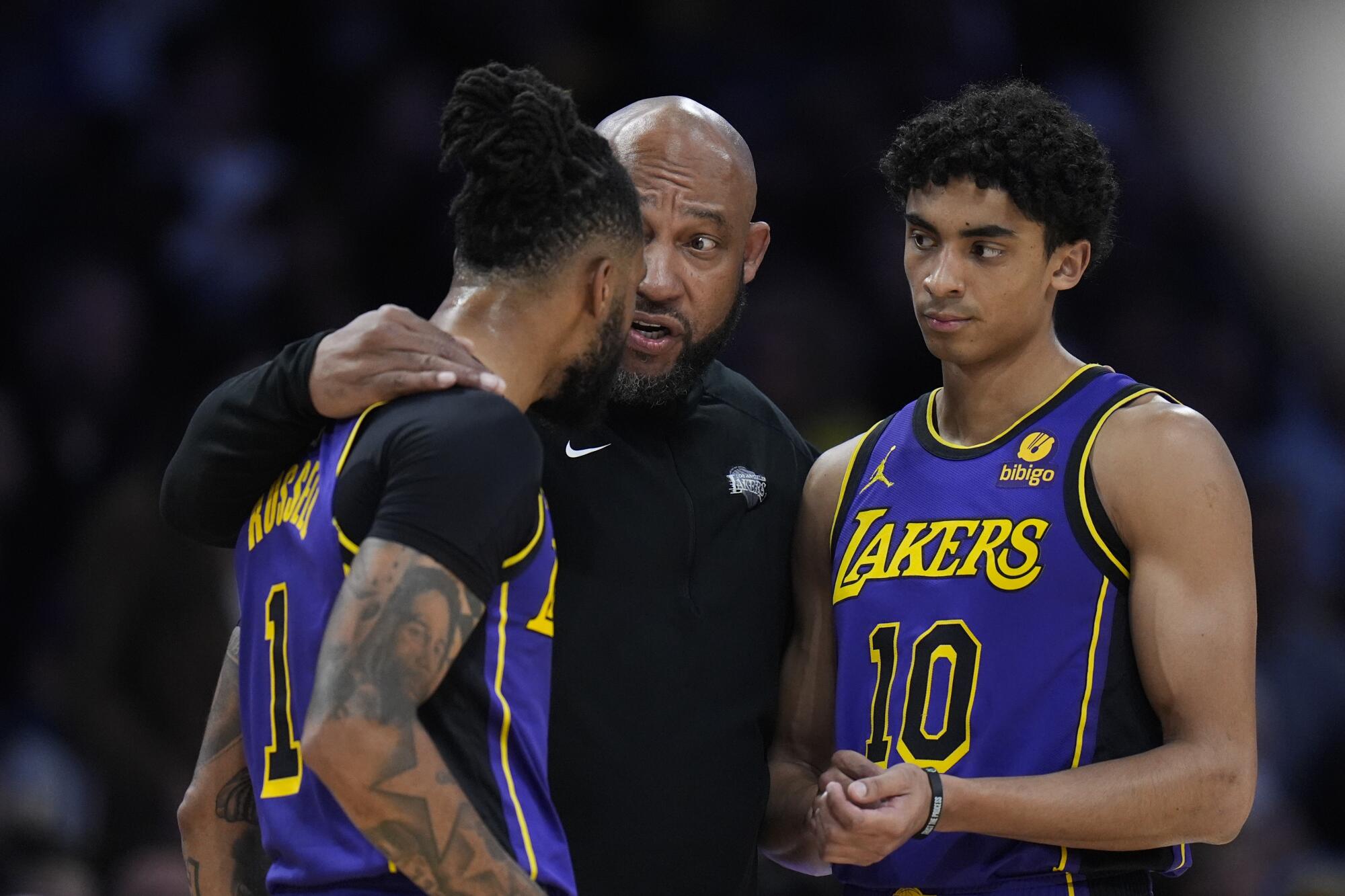 Lakers-Cheftrainer Darvin Ham (Mitte) spricht am Freitagabend mit den Guards D'Angelo Russell (links) und Max Christie.