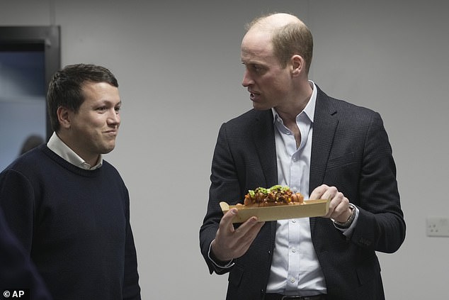 Prince William speaks to Pierre-Yves Paslierco, founder of Earthshot Prize winner Natpla, as he holds holds a sustainable seaweed-based food plate at the Oval cricket ground on Friday