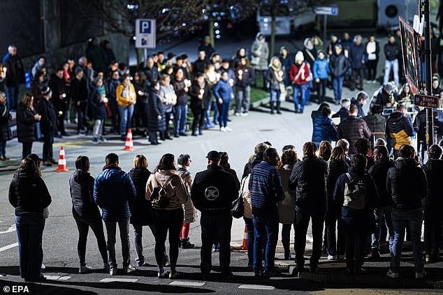 People attend a vigil after the bodies of five ski tourers were found near Tete Blanche in the Swiss alps mountains, in Vex, Switzerland, 11 March 2024