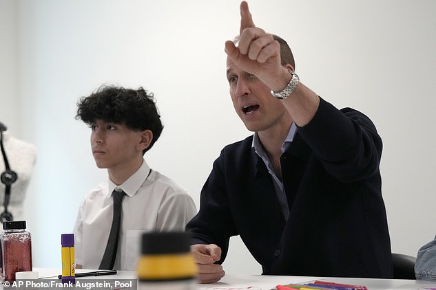 William gestures as he speaks with young people during his visit to West in White City today