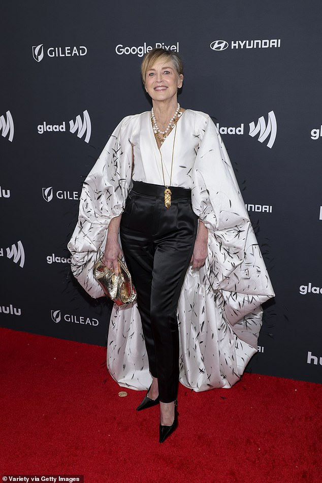 The Basic Instinct star, 66, hit the red carpet in a low-cut white satin blouse with a billowing train