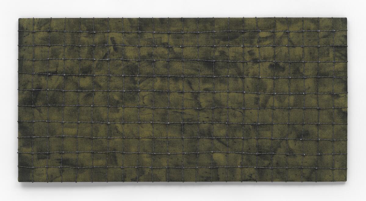 Eine große, horizontale, schlammfarbene, monochrome Abstraktion mit gemischten Medien, umhüllt von einem strengen Gitter aus Stacheldraht.