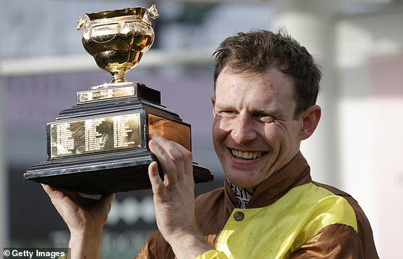 Jockey Paul Townend holds the trophy after victory on Galopin Des Champs in the Gold Cup during racing on day four of the Cheltenham National Hunt jump racing festival at Cheltenham Racecourse on March 17th 2023 in Gloucestershire, England (Photo by Tom Jenkins/Getty Images)