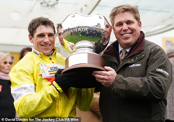 Harry Skelton and Dan Skelton lift the trophy after winning the Ryanair Steeple Chase with Protektorat on day three of the 2024 Cheltenham Festival at Cheltenham Racecourse. Picture date: Thursday March 14, 2024. PA Photo. See PA story RACING Cheltenham. Photo credit should read: David Davies for The Jockey Club/PA Wire.RESTRICTIONS: Editorial Use only, commercial use is subject to prior permission from The Jockey Club/Cheltenham Racecourse.