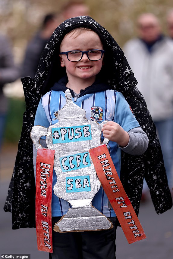 WOLVERHAMPTON, ENGLAND - MARCH 16: A Coventry City fan poses for a photo as he arrives at the stadium prior to the Emirates FA Cup Quarter Final match between Wolverhampton Wanderers and Coventry City at Molineux on March 16, 2024 in Wolverhampton, England. (Photo by Nathan Stirk/Getty Images)