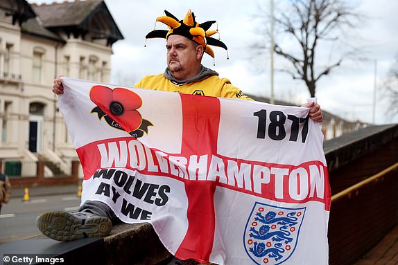 WOLVERHAMPTON, ENGLAND - MARCH 16: A Wolverhampton Wanderers fan poses for a photo prior to the Emirates FA Cup Quarter Final match between Wolverhampton Wanderers and Coventry City at Molineux on March 16, 2024 in Wolverhampton, England. (Photo by Nathan Stirk/Getty Images)