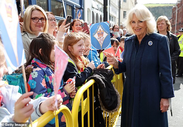 School children lined the streets of Douglas to welcome the Queen while waving handmade flags