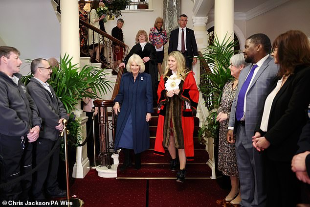 Members of the council stood at the bottom of the staircase as Camilla left the City Hall