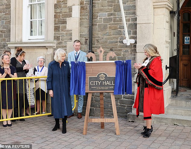 Crowds cheered as Camilla and the Mayor of Douglas (right) unveiled a commemorative plaque to mark the conferring City status on the Borough of Douglas